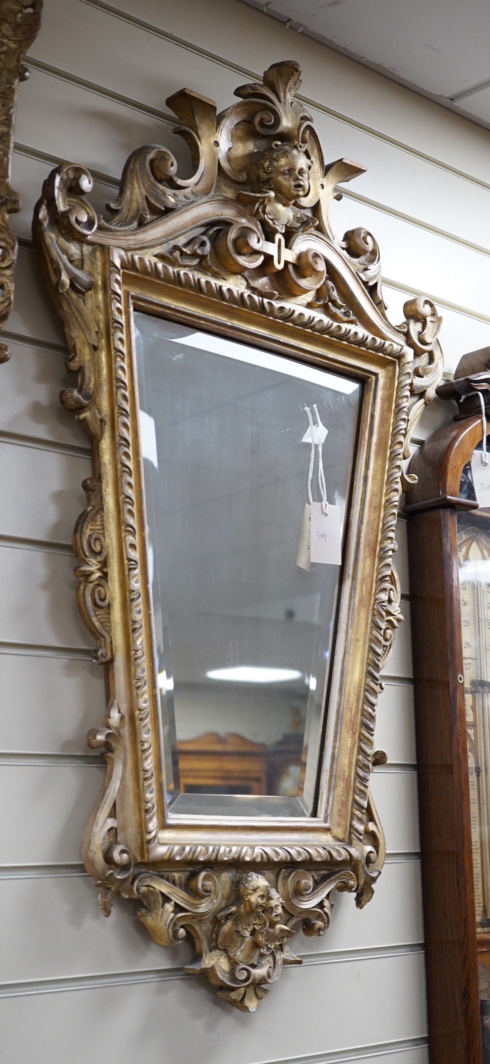 A late 19th century Continental giltwood cartouche shaped wall mirror, width 54cm, height 100cm *Please note the sale commences at 9am.
